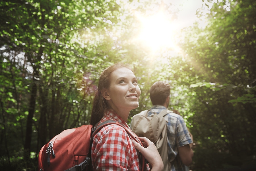 Happy couple hikes in the forest